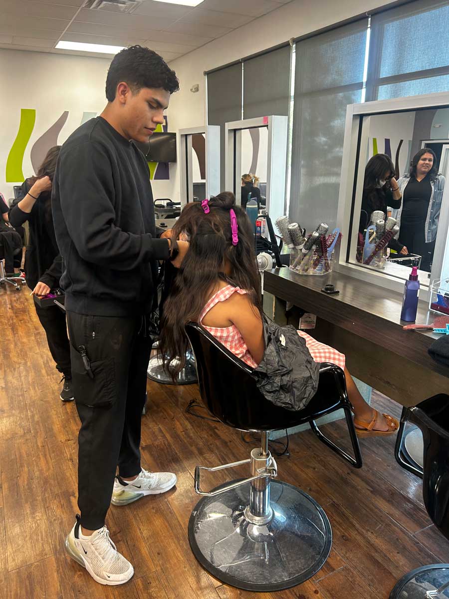 A girl getting her hair done at a salon